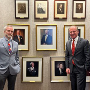 Frank H. Foster, Chair Emeritus, and Dylan Hixon, current Chair in front of past Chairs of Hixon family companies.